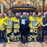 ​Members of the Arbroath crew are pictured at the lifeboat station with their commendation awards.