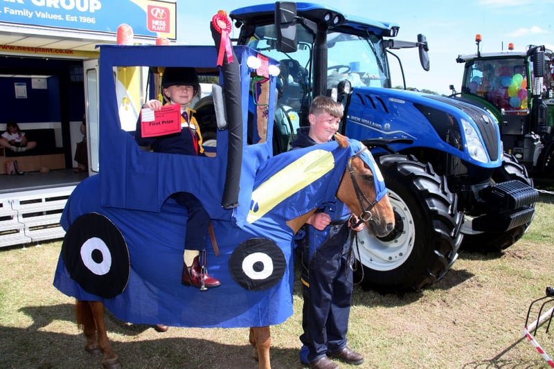 Molly Leith-McGaw with her pony Poppy, dressed as a four-hoof drive tractor, with brother Ritchie.