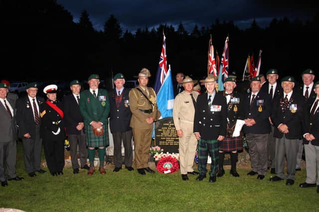The East of Scotland RMA pictured next to the grave with Australian servicemen. Pic: Wallace Ferrier.