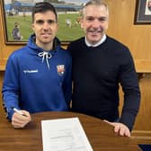 Terry Masson, left, signing a one-year contract extension with Montrose as manager Stewart Petrie looks on (Pic: Montrose FC)