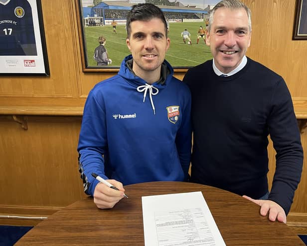 Terry Masson, left, signing a one-year contract extension with Montrose as manager Stewart Petrie looks on (Pic: Montrose FC)