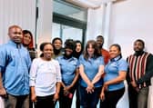 Innocent & Josephine Iba (left and front left) with members of their Blossom Home Care Aberdeen care team
