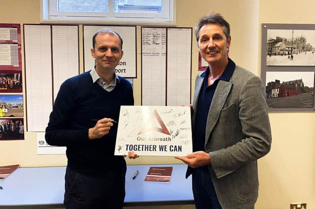 Mr Gethins is pictured at Arbroath Library with town board chairman Peter Stirling.