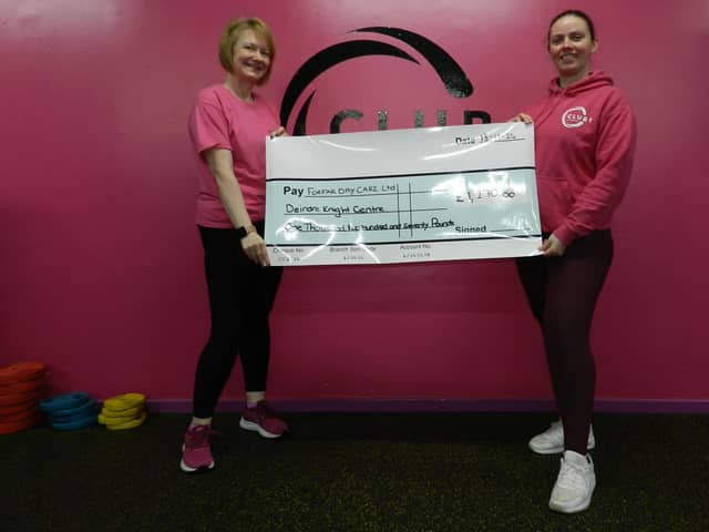 ​Kim McDonald (right) presents the cheque to Kathleen Blythe.