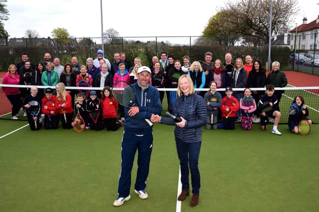 Montrose Tennis Club president Wendy Sanger congratulates Graeme Walker on his development coach of the year award from Tennis Scotland as club members gathered to celebrate that honour and Montrose’s club of the year award. Pic by Neil Werninck