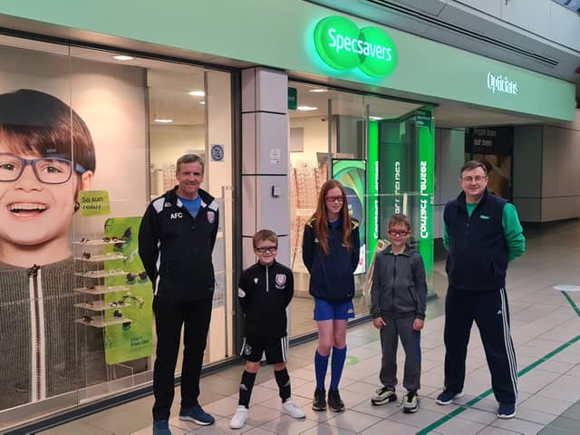 Pictured are David Durno, community trust trustee, members Harris, Kaydi and Carter and Jamie Buchan from Specsavers.