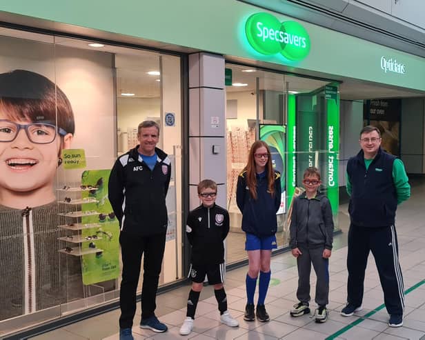 Pictured are David Durno, community trust trustee, members Harris, Kaydi and Carter and Jamie Buchan from Specsavers.