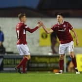 Goalscorer Michael McKenna, right, is congratulated on his equaliser by Joel Nouble, left, and David Gold (picture by Graham Black)