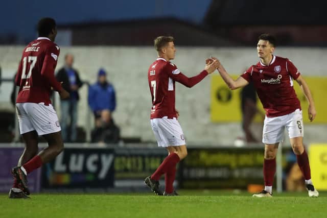 Goalscorer Michael McKenna, right, is congratulated on his equaliser by Joel Nouble, left, and David Gold (picture by Graham Black)
