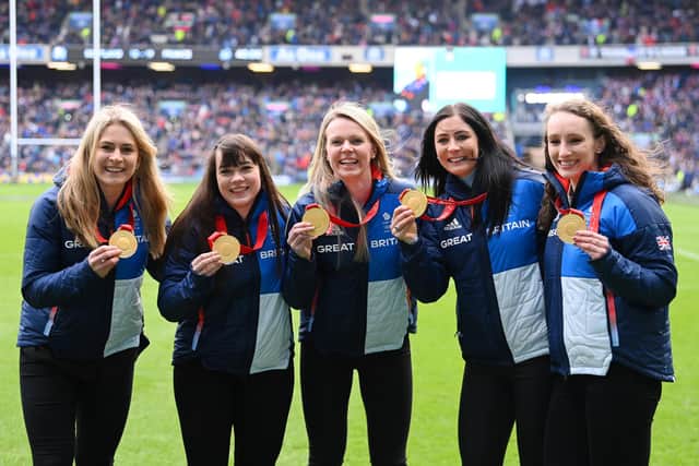 Curlers Millie Smith, Hailey Duff, Vicky Wright, Eve Muirhead and Jennifer Dodds pose for a photo with their Olympic Games Beijing 2022 gold medals during the Six Nations match between Scotland and France at BT Murrayfield Stadium. Photo by Stu Forster/Getty Images