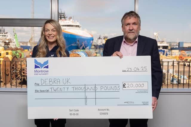Laura Forsyth accepts the £20,000 cheque from Montrose Port Authority CEO Tom Hutchison. (Pic: Jonathan Addie)
