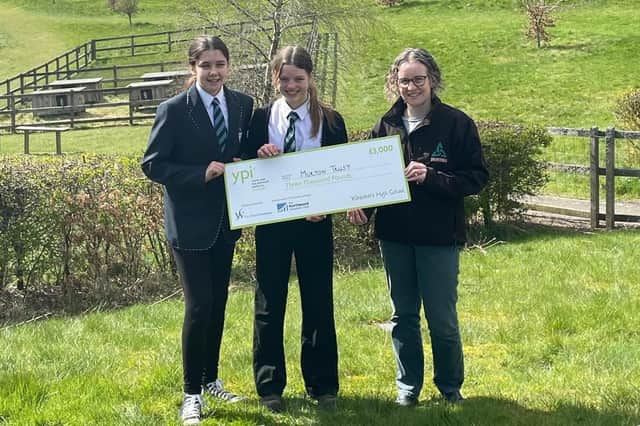 Carla and Willow are pictured presenting their £3000 cheque to Murton Trust manager Alison Elliott.