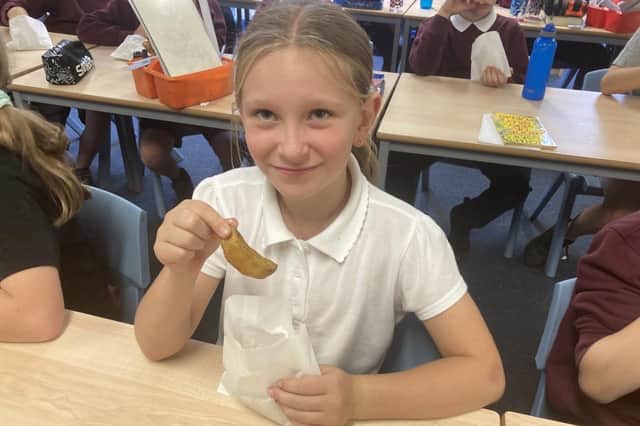 Emma Coventry, from Northmuir Primary, enjoys chips made from the school’s own crop of home-grown potatoes.