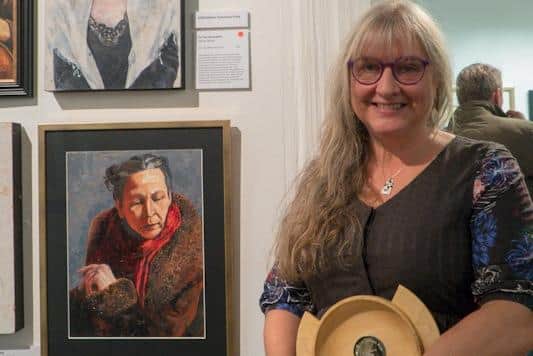Sylvia Tarvet with her work, ‘On her shoulders’.