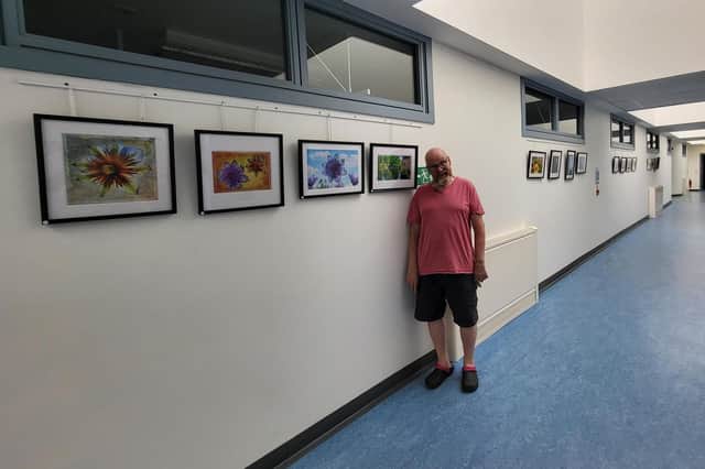 ​Ian Bain with some of his work, which is being exhibited at Whitehills Community Hospital.
