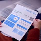 Woman looking at energy bill invoice.