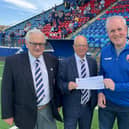 Pictured are Supporter Club members Stephen McCallum and Kevin Watson presenting the cheque to John and Club Honorary VP Malcolm Watters.