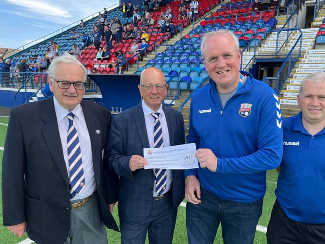 Pictured are Supporter Club members Stephen McCallum and Kevin Watson presenting the cheque to John and Club Honorary VP Malcolm Watters.