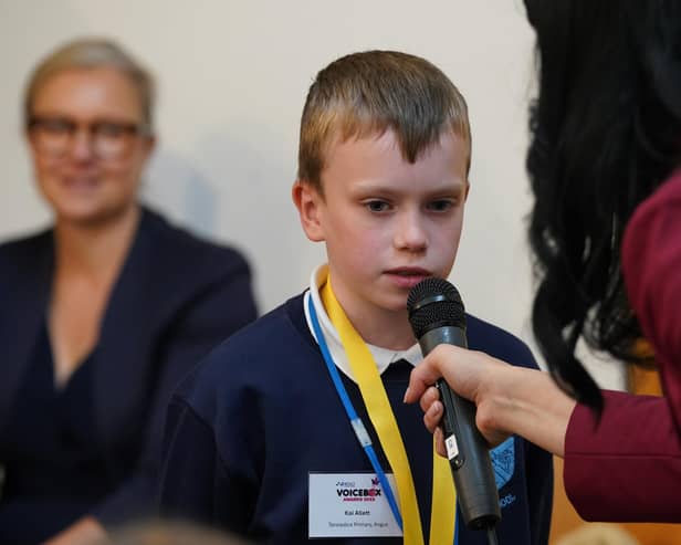 ​Kai delivers his joke to the audience at the Scottish Parliament.