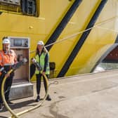 ​Captain Tom Hutchison and Maria Bos are pictured with one of the new power outlets. (Karen Jackson Photography)