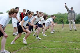 ​In June 2004 this was Monifieth High School Sports Day. These S2 girls were about to set off on their 70m hurdles race. The starting pistol was fired by biology teacher Bruce Lynch. Wonder why those boys were standing there.