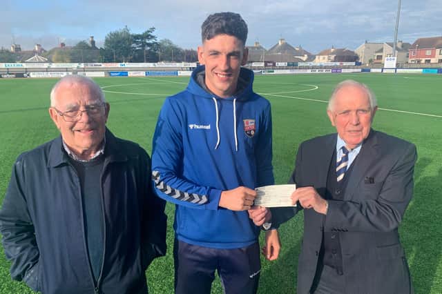 Martin is pictured receiving his bumper cheque from John Paton along with Montrose FC ticket agent Alan Pirie.