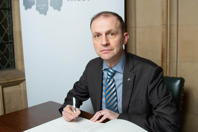 ​Stephen Gethins is pictured signing the Book of Commitment.