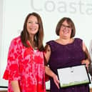 The group received its award from Rachel de Thame (left).