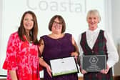 The group received its award from Rachel de Thame (left).