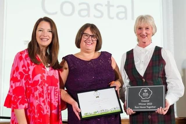 The group received its award from Rachel de Thame (left).