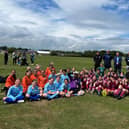 ​Angus South MSP Graeme Dey pictured at the sports day with organisers and pupils.