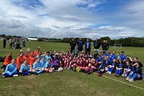 ​Angus South MSP Graeme Dey pictured at the sports day with organisers and pupils.
