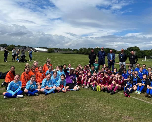 ​Angus South MSP Graeme Dey pictured at the sports day with organisers and pupils.