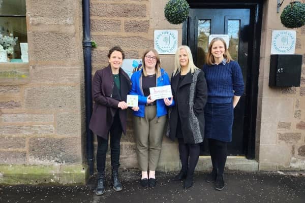 ​Mairi Gougeon is pictured with Little Beehive staff following their Millie’s Mark accreditation.