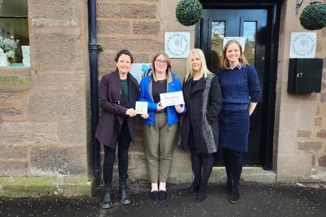 Mairi Gougeon is pictured with Little Beehive staff following their Millie’s Mark accreditation.