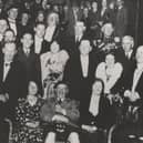 ​The gentleman seated front centre is Sir Harry Lauder, the famous Scottish singer and raconteur. What is not known, other than the fact that the it is in Angus, is the venue.