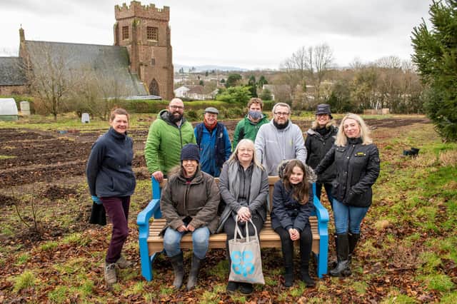 Kirriemuir Community Garden volunteers are pictured receiving a beautiful bench from representatives from the Roods Co-op. (Andy Thompson)