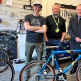 Graeme Dey is pictured with Scott Francis (left), David Evans (middle) and the bike he donated to the recycling scheme.