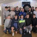 ​The Tunley Athletic team with darts player Luke Littler.