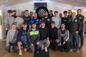 ​The Tunley Athletic team with darts player Luke Littler.