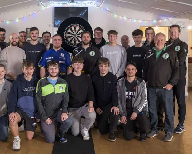 ​The Tunley Athletic team with darts player Luke Littler.