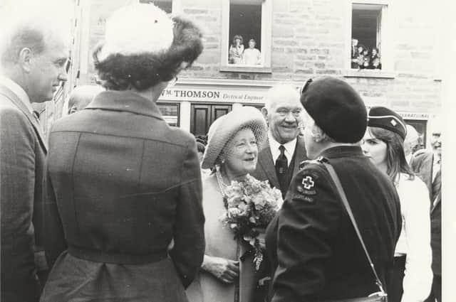 On an unknown date, Her Majesty Queen Elizabeth, the Queen Mother visited Forfar where various Angus people were presented to her. Here, she is meeting Jean Cuthill, of the Red Cross.