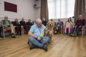 Alex Collie is pictured with therapy dog Isla at the opening of the new dementia meeting centre. (Andy Thompson)