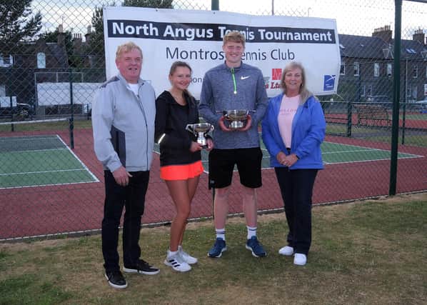 North Angus Tennis Tournament singles winners Patrick Young and Alicia Gates with their trophies handed out by tournament sponsors Doug and Sandra Cree of DC Lighting Services Ltd.