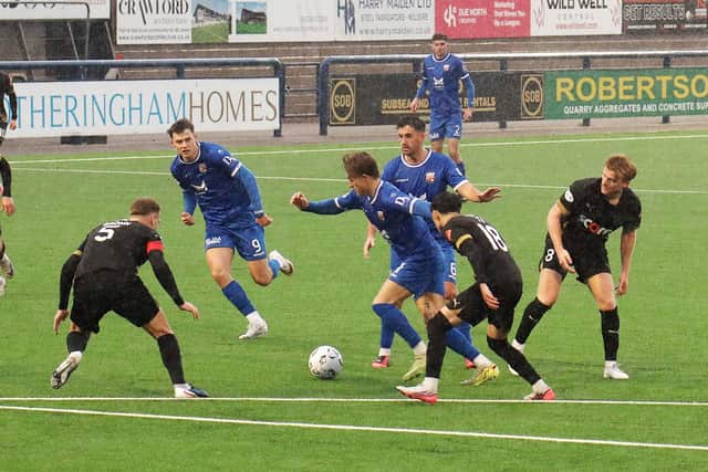 Blair Lyons runs at the Peterhead defence as Montrose won 3-0 in horrendous conditions (pic: Phoenix Photography)