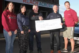 WestRock staff present their cheque to local charity ReachAcross at its Guthrie Port offices. (Wallace Ferrier)