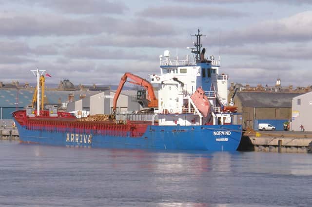 Haugesund-registered cargo ship Norvind loading logs at Montrose.