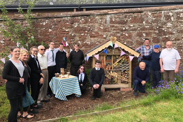 Pupils and guests are pictured at the opening of the Kirrie Connections bughouse. The pupils also prepared and served their own snacks during the morning.