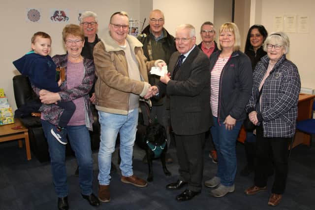 Brian presented his cheque to Dr Stanley Callaghan. (Wallace Ferrier)