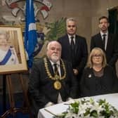 Lord Provost Bill Campbell, Lady Provost Yvonne Campbell, council leader John Alexander and chief executive Greg Colgan with the Book of Condolence.
